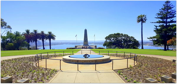 Scenic view of park against clear blue sky