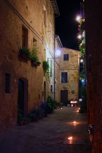 Street amidst buildings in city at night