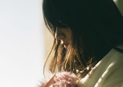 Close-up portrait of woman with hair at home