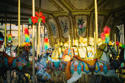 Illuminated carousel in amusement park at night