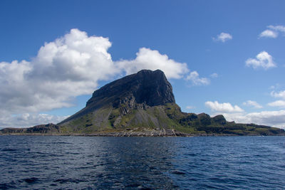 Scenic view of sea and mountains against sky