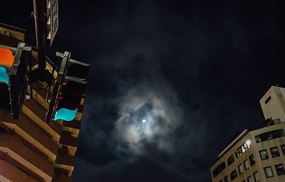 Low angle view of illuminated city against sky at night