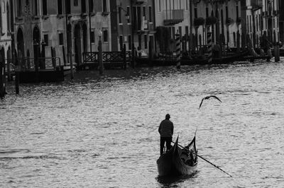 Rear view of man on boat in sea