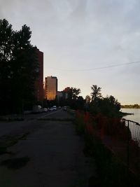 Empty road along buildings