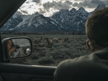 Rear view of car on mountain against sky