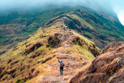 Rear view of man standing on mountain