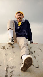 Portrait of a smiling young man sitting on land