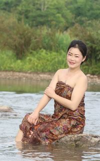 Portrait of smiling young woman in water