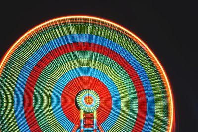 Multi colored illuminated lights against black background