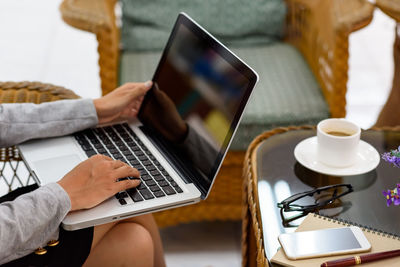 Midsection of woman using mobile phone