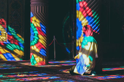 Multi colored umbrella on illuminated street at night