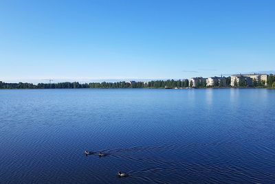 Scenic view of sea against clear blue sky