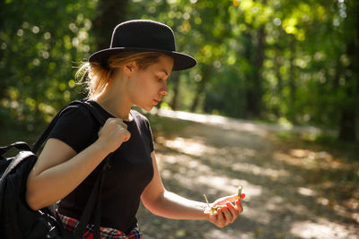 Portrait of young woman standing in forest