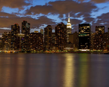 Illuminated buildings against sky at night