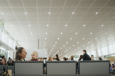 Mother with baby waiting at airport