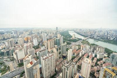 High angle view of modern buildings in city against sky