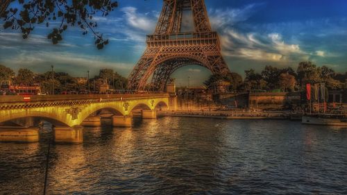 View of bridge over river against sky in city