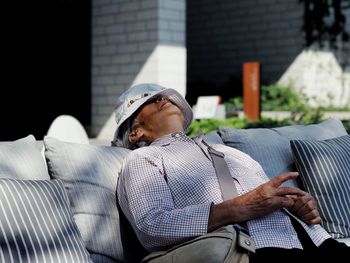 Midsection of man sitting outdoors