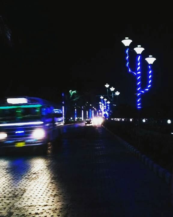 ILLUMINATED CARS ON ROAD AT NIGHT