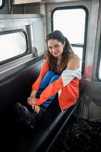 Portrait of smiling young woman sitting in car