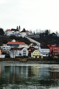 Buildings in city against clear sky