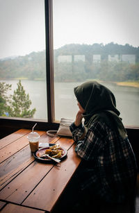 Woman having food and drink in restaurant