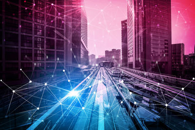 Aerial view of illuminated buildings in city at night