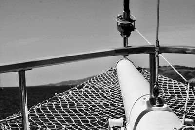 Close-up of ship sailing on sea against sky