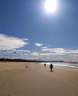 People on beach against sky