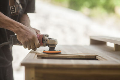 Midsection of man working in workshop