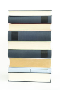 Close-up of books on table against white background