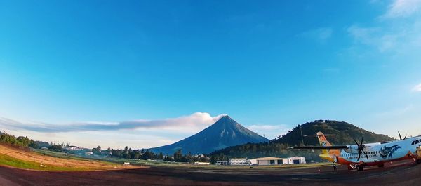 Scenic view of mountains against blue sky