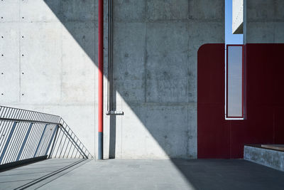 Empty footpath by wall of building