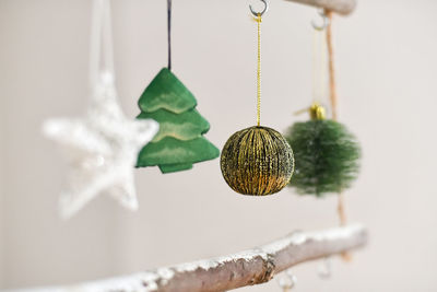 Handmade wooden christmas tree with toys hanging on the wall