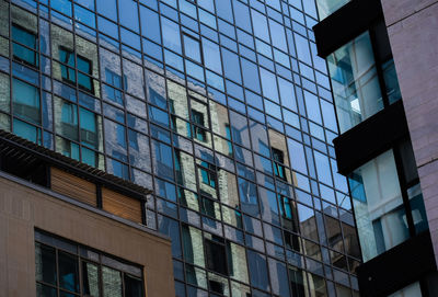 Low angle view of modern building against clear blue sky