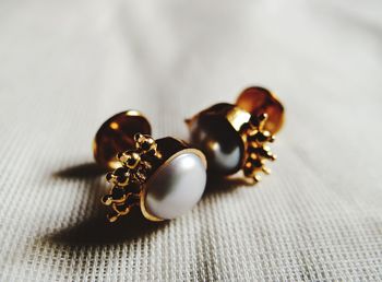 Close-up of earrings on table