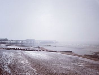 Road by sea against clear sky