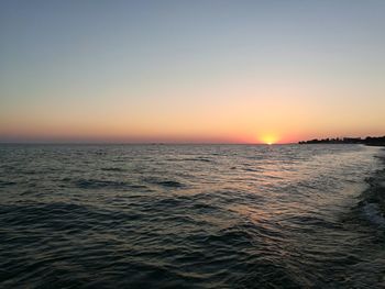 Scenic view of sea against clear sky during sunset