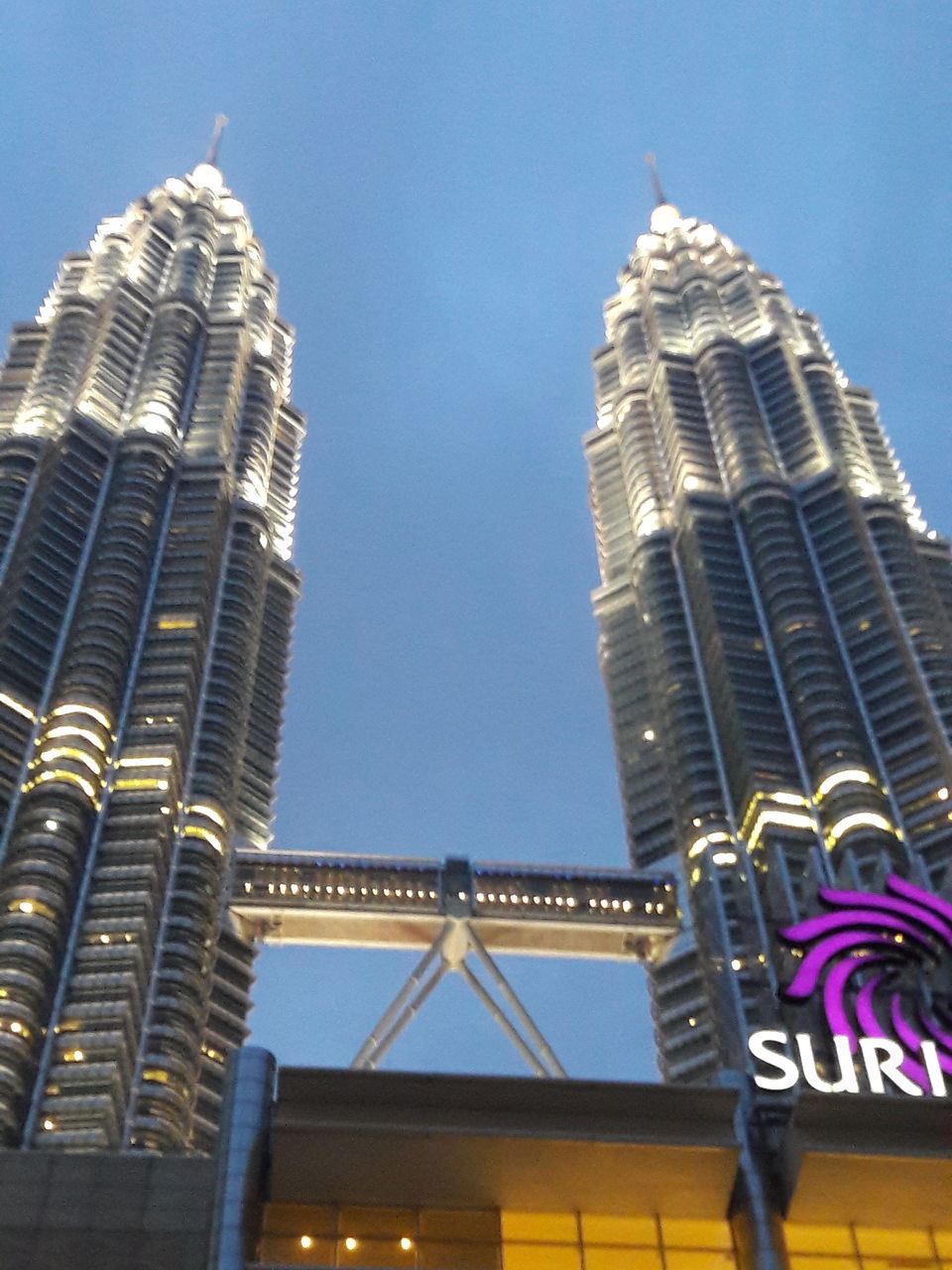 LOW ANGLE VIEW OF ILLUMINATED SKYSCRAPERS AGAINST SKY