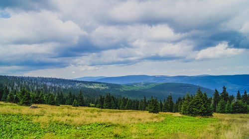 Scenic view of mountains against cloudy sky