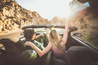 Rear view of women sitting in car