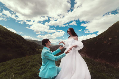 Man, a woman and a marriage proposal in the mountains. couple, engagement and ring proposal in