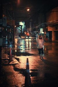 Person walking on city street at night