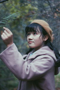 Close-up of girl holding plants