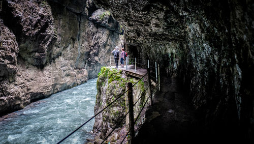 Rear view of man in cave