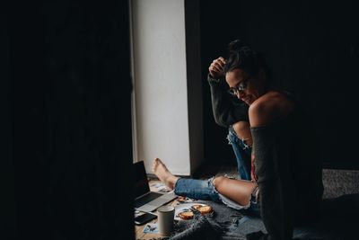 Thoughtful woman siting at home