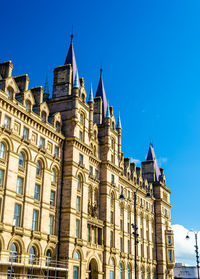 Low angle view of buildings against blue sky