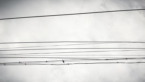 Low angle view of electricity pylon against sky