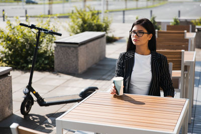 Young woman sitting on table