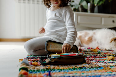 Side view of girl choosing color pens